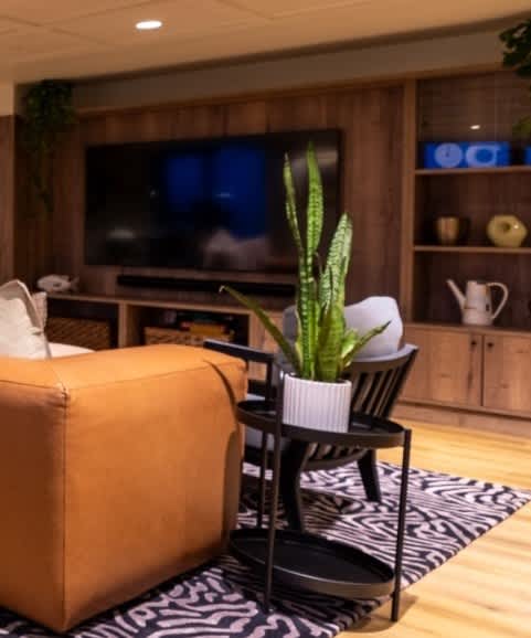 a living room with a blue couch and a wooden table