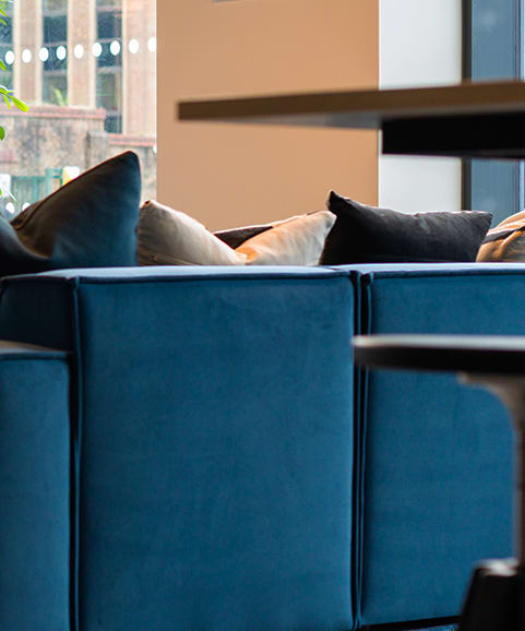 a living room with a blue couch and a wooden table