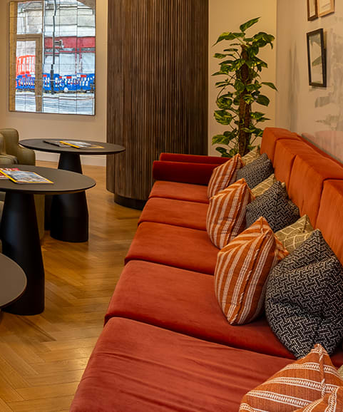 a living room with a blue couch and a wooden table