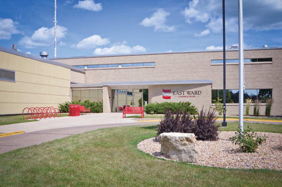a building with a sign that says   and a rock