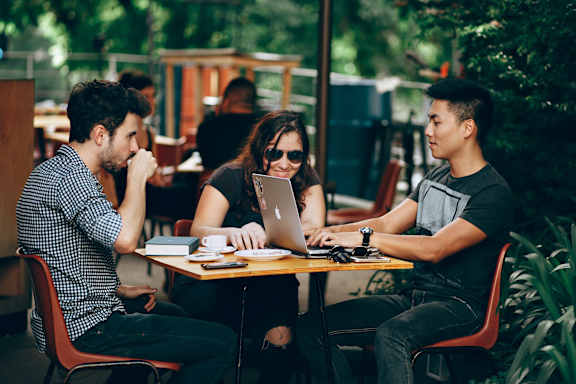 Group of people studying outside of a coffee shop