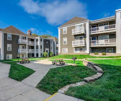 A sunny day at a residential complex with a clear blue sky.