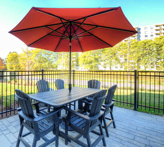 a patio with a table and chairs and an umbrella