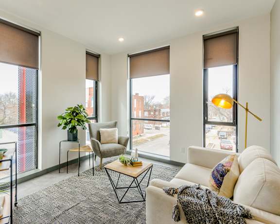 A living room with a couch, chair, and table.