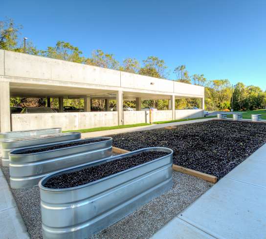 a view of the garden from the sidewalk in front of the building