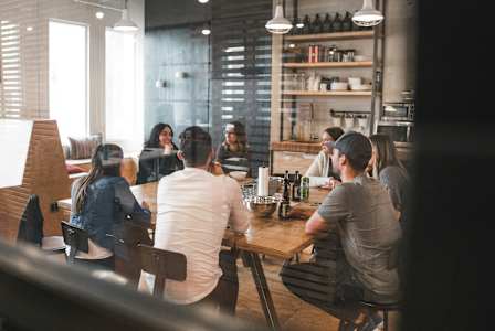 A group of people are sitting at a bar with a bartender behind the counter. at Eagles Landing, Ammon, ID, 83406
