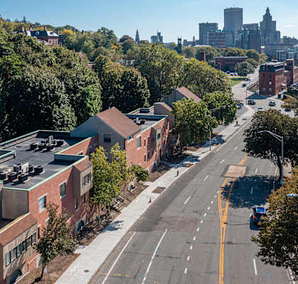 an aerial view of a city street with buildings and trees