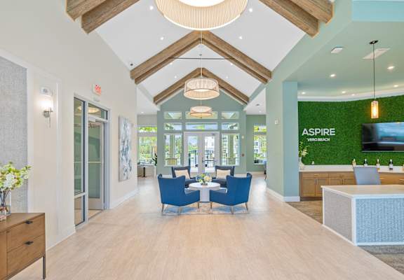 a dining room with blue chairs and a table in the middle