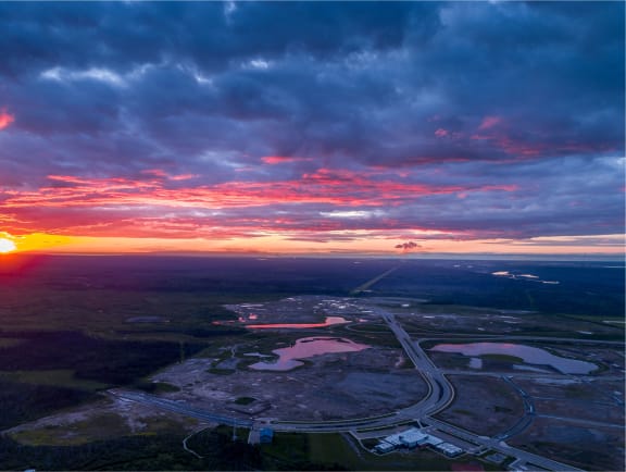 an aerial view of the airport at sunset