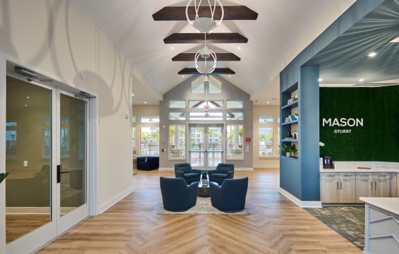 a large fitness room with a lot of exercise equipment and lots of windows