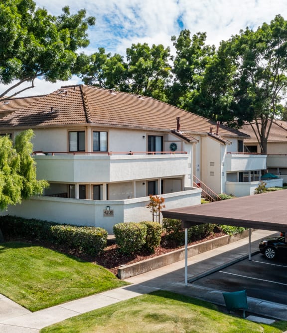 a house with a garage and a tree in front of it at  Cowell Terrace Apartments 94518, Concord, CA, California