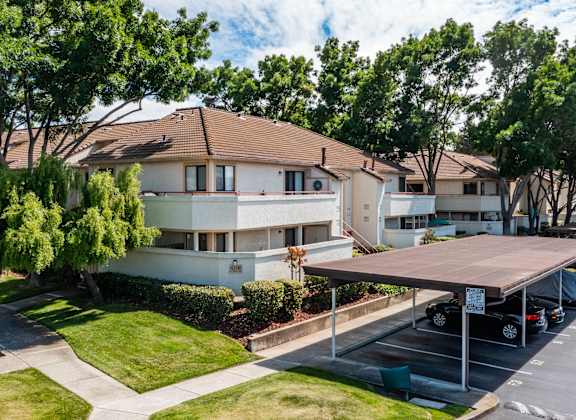 an apartment building with a parking lot in front of it at Cowell Terrace Apartments California