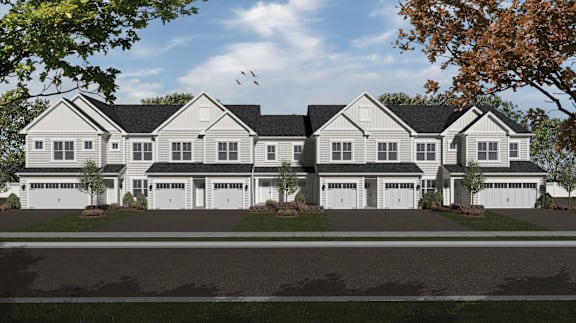 A row of houses with trees in front.
