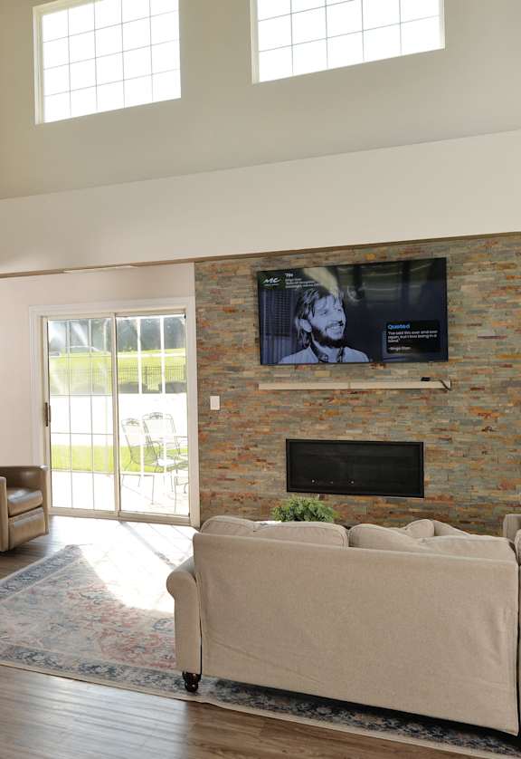 a living room with a fireplace and a pool table