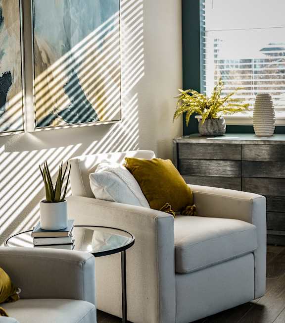 a desk with a chair and a lamp in a room