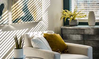 a living room with a white couch and a glass table