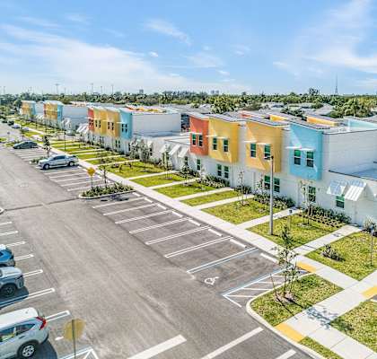 a row of colorful houses in a parking lot