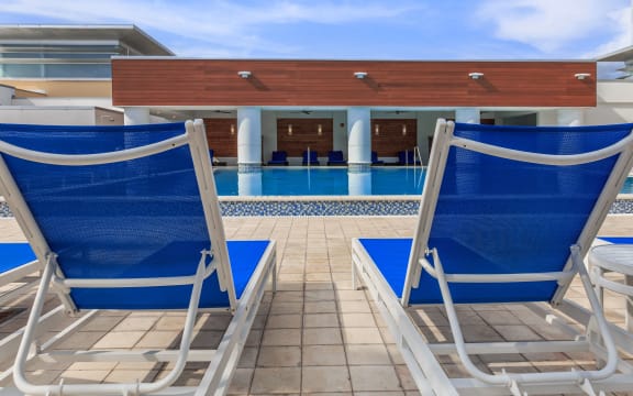 a swimming pool with a blue and white deck chair