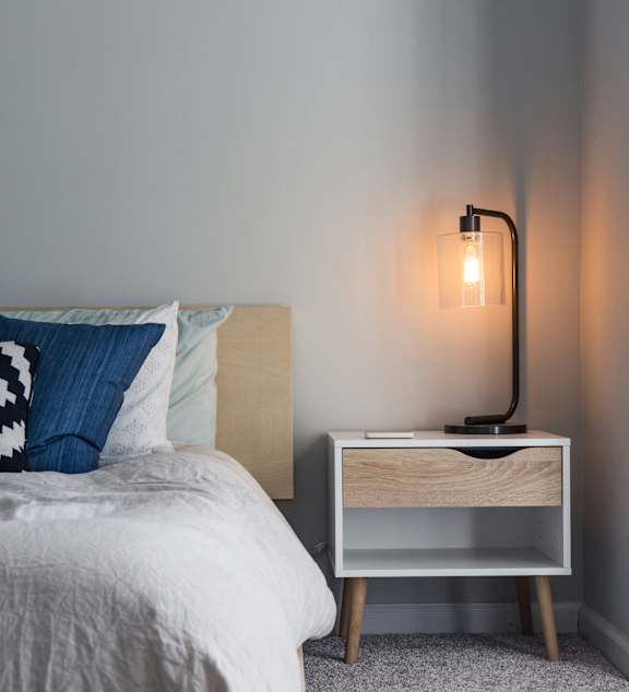 a bedroom with a large bed and a ceiling fan
