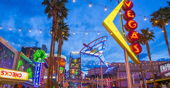 A brightly lit Las Vegas sign stands tall in the city's bustling streets.