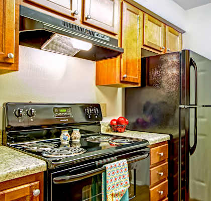 a kitchen with green appliances and wooden cabinets