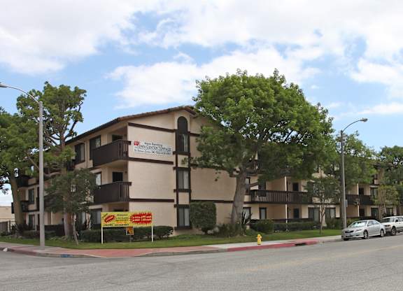 Apartment building with a yellow sign in front of it.