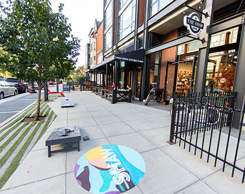 a skateboard sitting on the sidewalk in front of a building