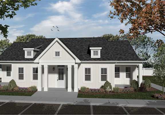 A white house with a black roof and a front porch.