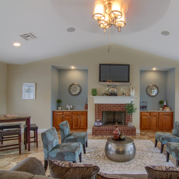 a large living room with a fireplace and a flat screen tv