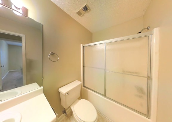 a bathroom with a toilet sink and bathtub