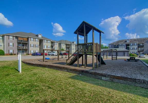 a playground at the whispering winds apartments in pearland, tx