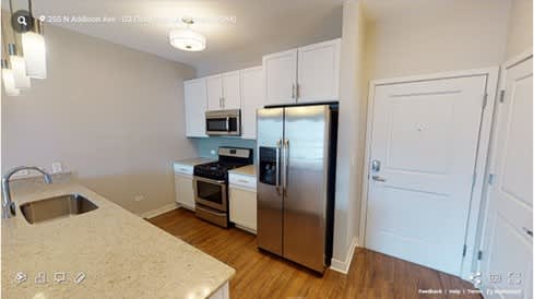 A kitchen with a sink, stove, and refrigerator.