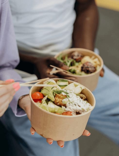 Two people holding food bowl at Lynk De la Savane Apartments, Montreal