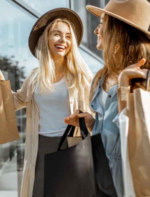 Two women carrying shopping bags at Lynk De la Savane Apartments, Montreal, Québec