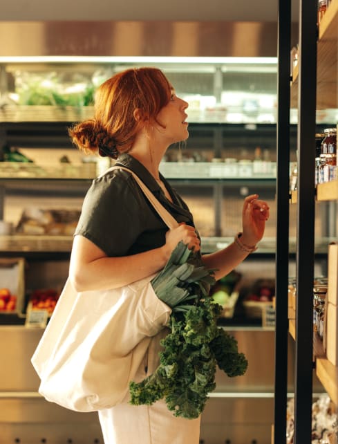 A woman holding grocery shopping at Lynk De la Savane Apartments, Québec
