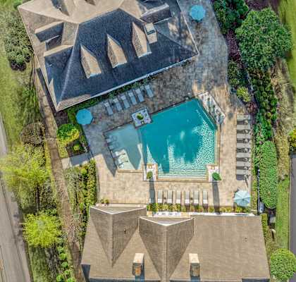 A large house with a pool in the backyard.