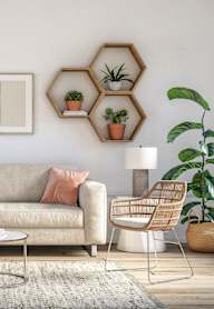 A living room with a grey couch, a coffee table, and a plant.