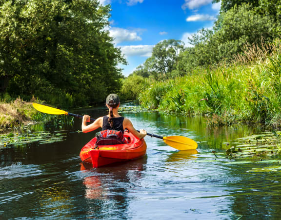 a woman in a kayak on a river at Rivulet, Silverdale Washington