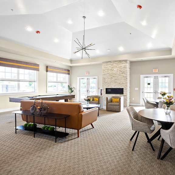 an open concept living room and dining area with a white dining table and rattan chairs