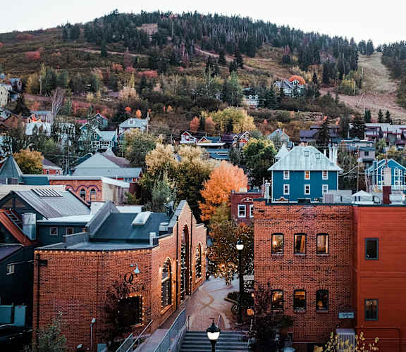 an aerial view of a city with a mountain in the background