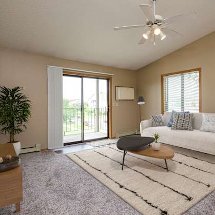 Flickertail I-VI Apartments | living room with beige walls and a sliding glass door leading to a balcony