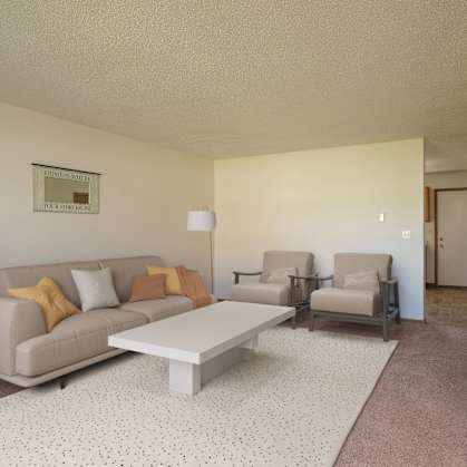 a living room with a couch and chairs and a coffee table. Fargo, ND Hazelwood Townhomes
