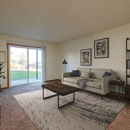 an open living room with a couch and a coffee table. Fargo, ND Maybrook Apartments