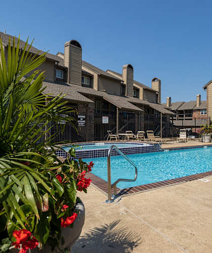 our resort style swimming pool is next to a brick building