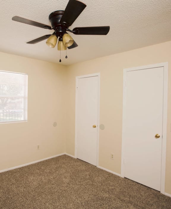 an empty room with three doors and a heater on the wall