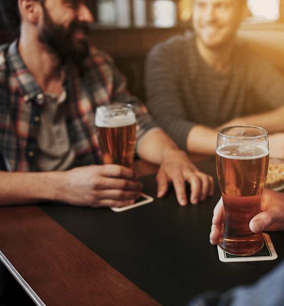 people drinking beer at a bar
