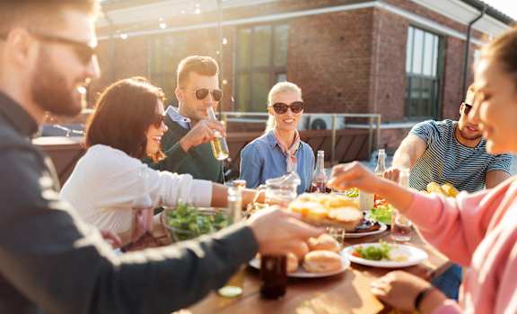a group of people sitting around a table eating food