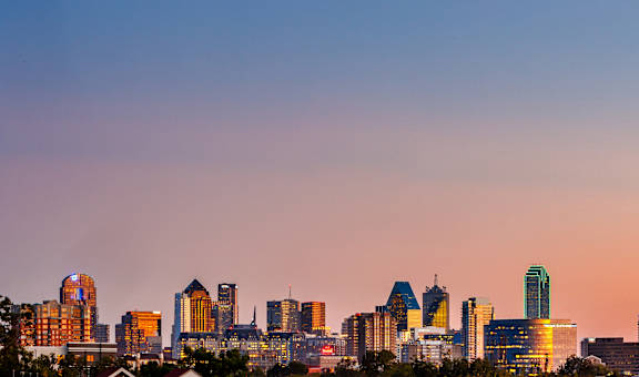 a view of the dallas skyline at sunset