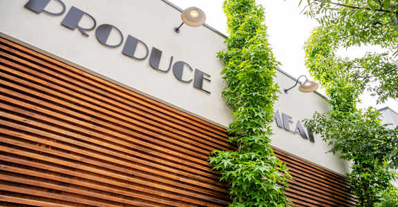A sign that says "Produce" is on a wall.