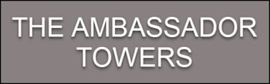 The Ambassador Towers logo on a grey background.